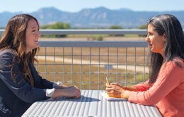 colleagues having a conversation outside on a table