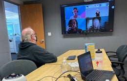 Lakeside Speakeasy Toastmasters members participate in a hybrid meeting with members in the Oakland office and on Zoom.