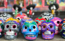 Array of colorful sugar skulls on a table