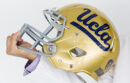 Doctor holding UCLA football helmet