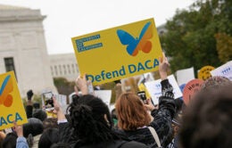 Gathering of people in front of the U.S. Supreme Court with "Defend DACA" signs