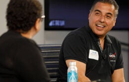 UC regent José Hernández speaks with Yvette Gullatt at the 2022 Grad Slam