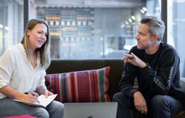 Colleagues having a conversation on a couch