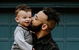 Man kissing child