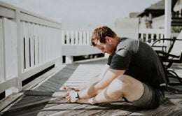 Man stretching on porch