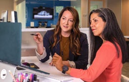 Women discussing something on a computer screen