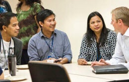 Colleagues chatting around a table