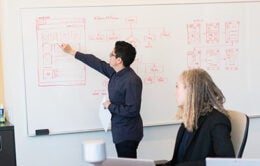 Person demonstrating something on a whiteboard