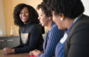 Women talking around a conference table