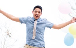 UC Merced student jumping with balloons
