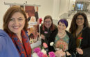 PACSW members Lily Dimitrova, Jackie DiOiro, Blaze Farrar and Marisa Strong distribute flowers to UCOP staff on International Women’s Day, March 8, 2023