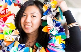 UC Merced student holding a paper flower lei