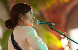 Woman singing and playing guitar