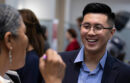Young man talking to woman at career fair in 2019