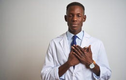 Doctor holding his hands over his heart