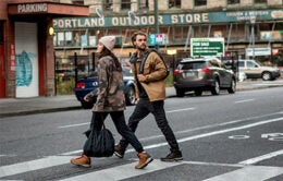 Woman and man walking through a city