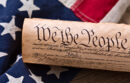 United States Constitution, rolled in a scroll on a vintage American flag and rustic wooden board
