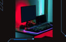 Desktop computer backlit in red and purple