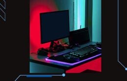 Desktop computer backlit in red and purple