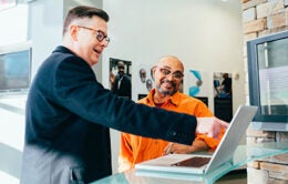 Men working at a computer together