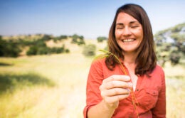 Woman holding grass at Sierra Foothill Research and Extension Center