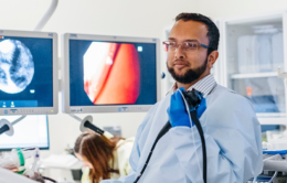 Doctor in front of computer monitors