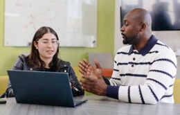 Colleagues working at a computer