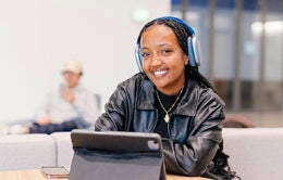 Woman sitting in front of computer smiling