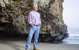 UC researcher standing on the beach in California