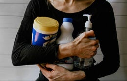 Woman holding cleaning products
