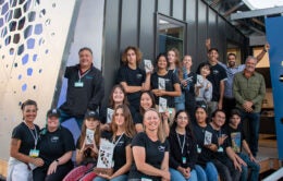 UC Irvine students and staff pose in front of the luminOCity house they built.