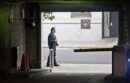 Security guard walking past the entrance gate in the Franklin St. garage