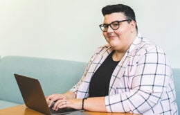 Nonbinary person working on a computer