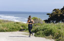 Woman running beside the ocean at UC Santa Barbara