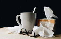 Glasses, mug of tea and tissues