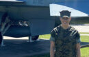 Marissa Cash in her Marine Corps uniform in front of an airplane