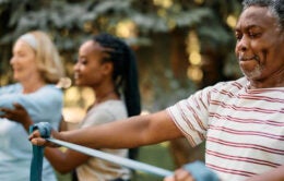 People exercising outdoors using giant rubber bands
