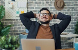 Man stretching at his desk