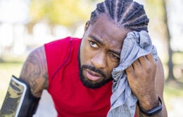 Man wiping sweat off of his face