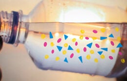 Person drinking water out of plastic bottle