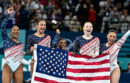 Team USA gymnasts holding the American flag