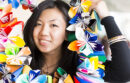 Student wearing a lei made out of colorful folded paper