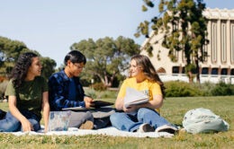 UC Irvine students sitting on the grass