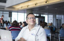 Man working on his laptop in a cafeteria