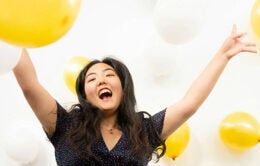 Girl holding balloons