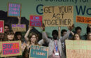 Children hold signs protesting climate change at COP29.