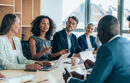 Multiethnic group of businesspeople sitting together and having a meeting in the office.