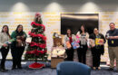 Members of UCPath's Latinx Staff Association pose with some of their group's donated gifts.