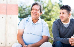 Older and younger men sitting together