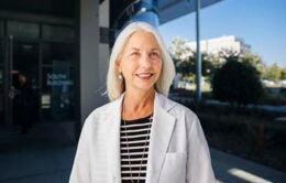 Woman standing outside wearing lab coat